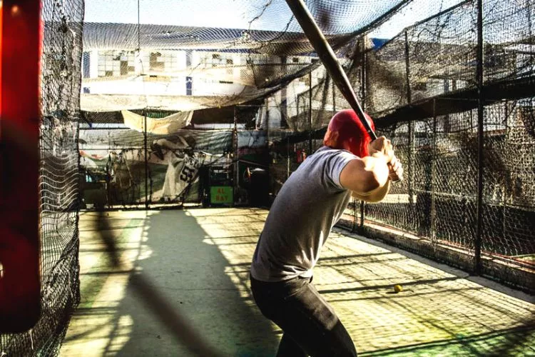 Practice with a batting cage