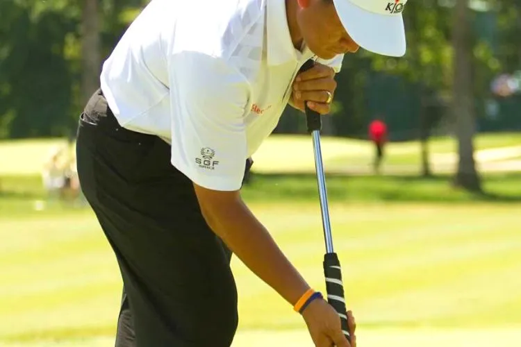 Why do golfers stand astride their putts